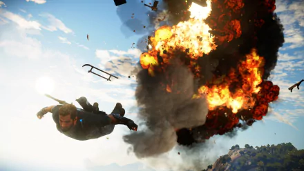 Rico Rodriguez from Just Cause 3 freefalls away from a massive fiery explosion in this HD PC desktop wallpaper showcasing intense video game action.
