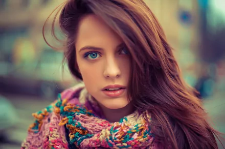 A close-up of a woman with long, flowing hair, wearing a colorful scarf, showcasing her expressive face and captivating blue eyes. This HD image serves as a vibrant desktop wallpaper.