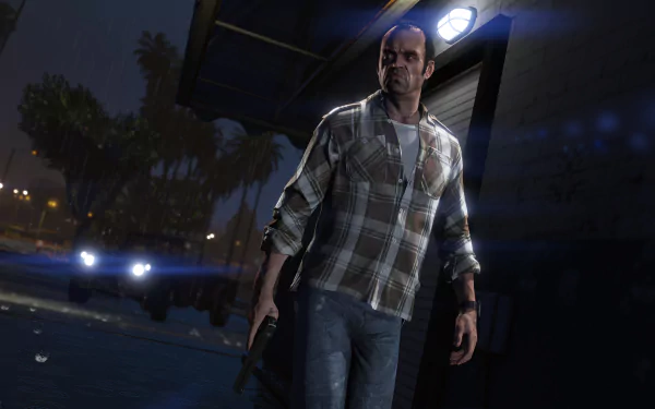 Trevor Philips stands in a dimly lit setting, holding a gun, showcasing intense detail in this 4K Ultra HD wallpaper from the video game Grand Theft Auto V.