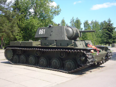 Military Kliment Voroshilov tank on display in a park, shown as a 2K Quad HD PC desktop wallpaper and background, olive-green heavy tank with turret marked 061.