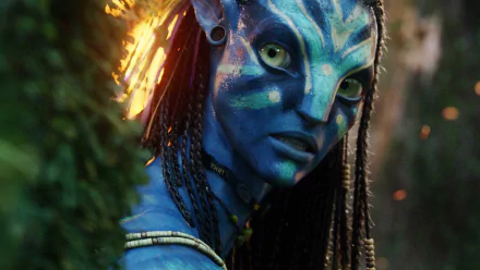 HD PC desktop wallpaper featuring a close-up of a blue-skinned character from the movie Avatar with glowing accents and detailed facial features.