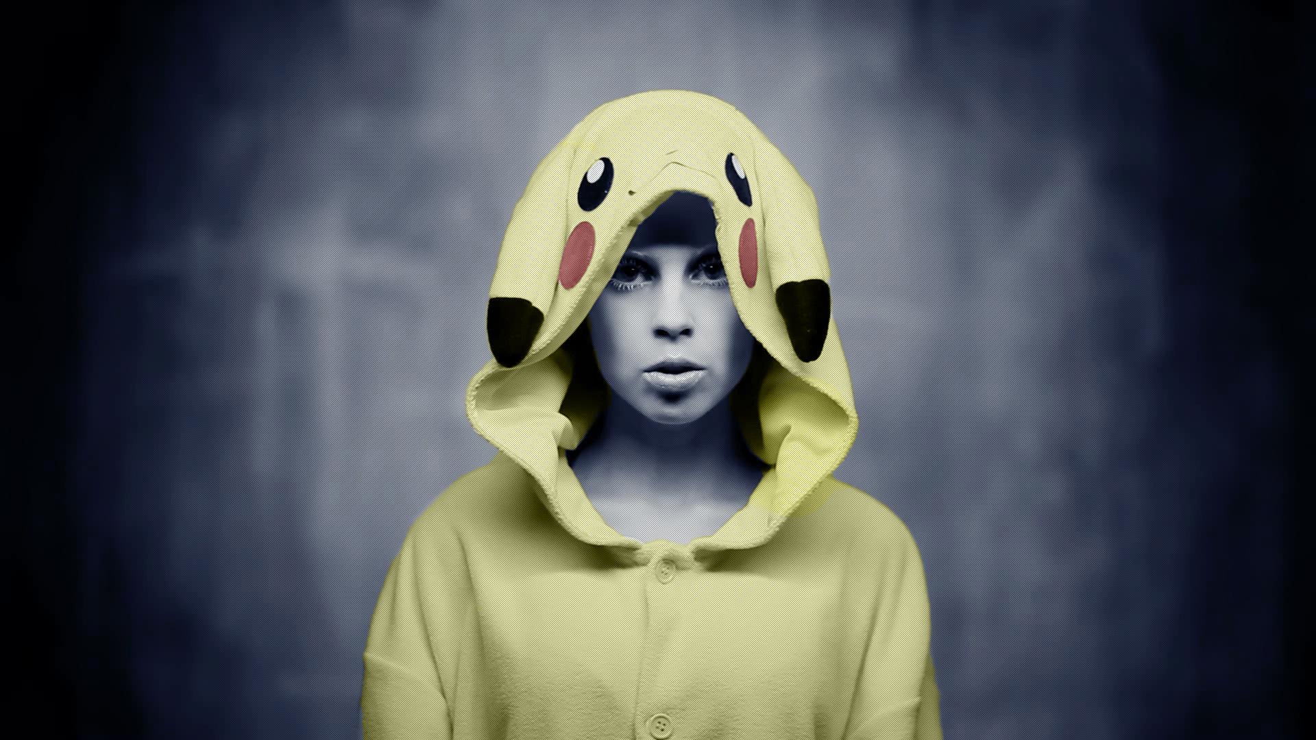 Yolandi Visser wearing a Pikachu-themed cosplay hoodie, featured in an HD PC desktop wallpaper with a dark, blurred background.
