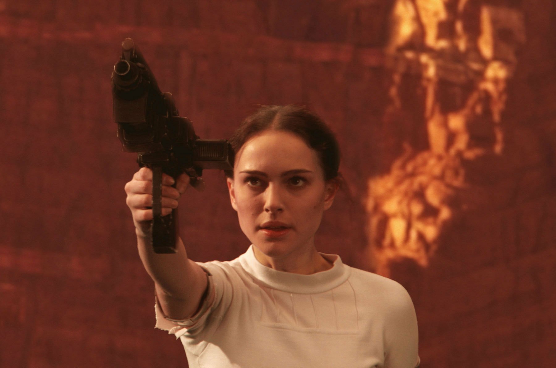 HD Star Wars PC desktop wallpaper featuring a determined character aiming a blaster in a dimly lit, reddish environment.
