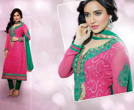 HD wallpaper featuring Indian model Neha Sharma wearing a vibrant pink national dress adorned with green and gold embellishments, set against a soft, blurred background.