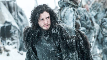 HD PC desktop wallpaper featuring Jon Snow from the TV show Game of Thrones, dressed in black fur with a snowy battlefield background.