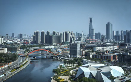 HD desktop wallpaper showing the modern cityscape of Tianjin, China, featuring a river, bridges, and high-rise buildings under a clear sky.