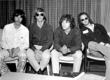 Black and white HD desktop wallpaper featuring the rock band The Doors seated side by side in a casual setting.