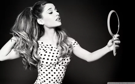 HD desktop wallpaper featuring a black and white image of a woman in a polka dot dress, holding a mirror, with her hair styled in a high ponytail.