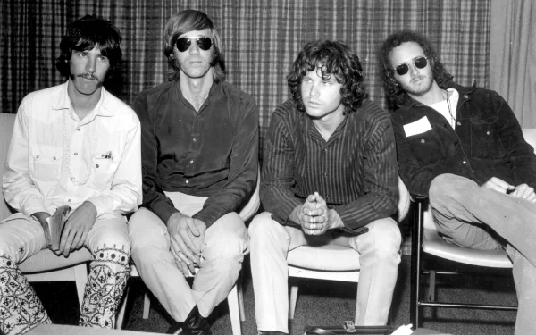 Black and white HD desktop wallpaper featuring the rock band The Doors seated side by side in a casual setting.