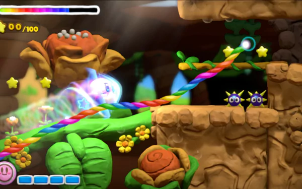 HD desktop wallpaper from Kirby and the Rainbow Curse featuring Kirby in an in-game action scene.