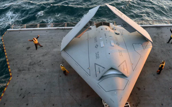 Top-down view of a Northrop Grumman X-47B unmanned military aircraft on an aircraft carrier deck with crew, 2K Quad HD PC desktop wallpaper and background.