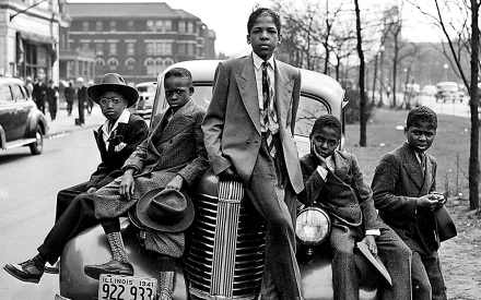 Black & White photography HD PC desktop wallpaper and background: five boys in suits leaning on a vintage car on a city street, 1940s-era urban scene with buildings and bare trees.