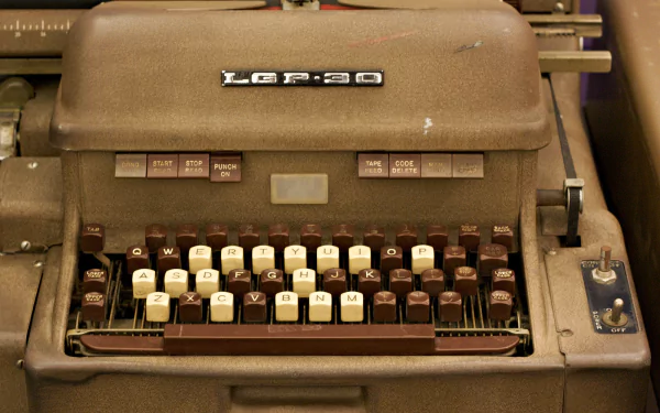 HD desktop wallpaper of a vintage man-made typewriter with a close-up view of its keys and brand label, showcasing its classic mechanical design.