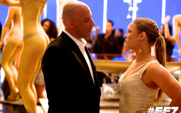 HD wallpaper featuring Ronda Rousey and Vin Diesel as Dominic Toretto in a scene from the movie Furious 7, set in a vibrant, stylish environment.