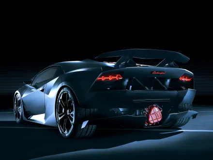A sleek Lamborghini Sesto Elemento, showcased from the rear, illuminated against a dark background. This high-definition image serves as an impressive desktop wallpaper.