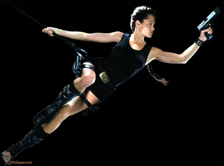 HD PC desktop wallpaper featuring Lara Croft from the movie Lara Croft: Tomb Raider in an action pose with a gun against a black background.