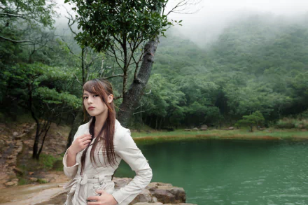 Asian woman standing in a serene forest by a misty lake, creating a tranquil HD desktop wallpaper and background.