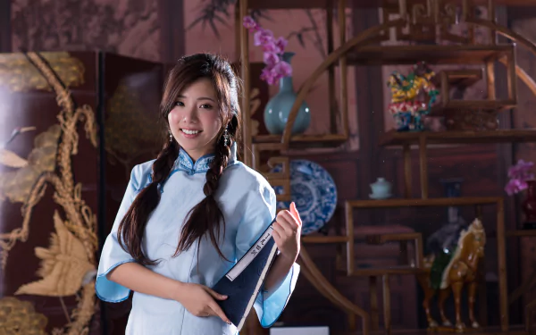 A smiling Taiwanese woman in traditional attire holds a copybook beside a vase with orchids, set against an ornate wooden background in 4K Ultra HD quality.