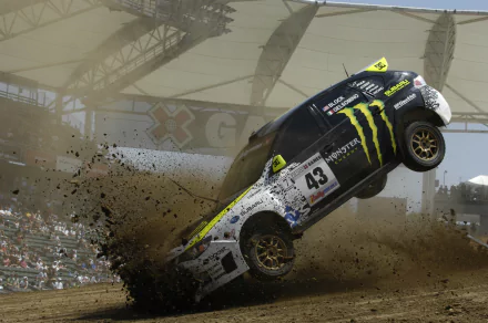 4K Ultra HD PC desktop wallpaper: Subaru Impreza rally vehicle airborne in a stadium, mud spraying from its wheels.