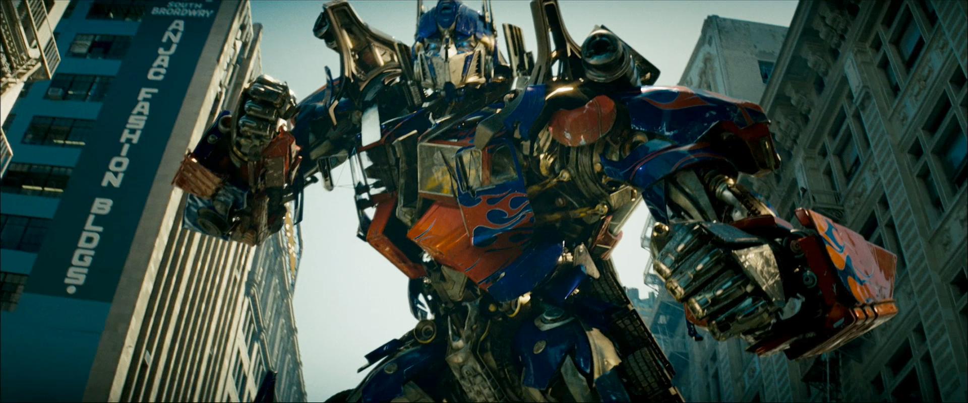 Optimus Prime standing tall in a vibrant HD desktop background.