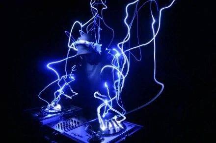A DJ creates an electrifying atmosphere with blue light trails surrounding turntables in this HD desktop wallpaper and background tagged with music and DJ.
