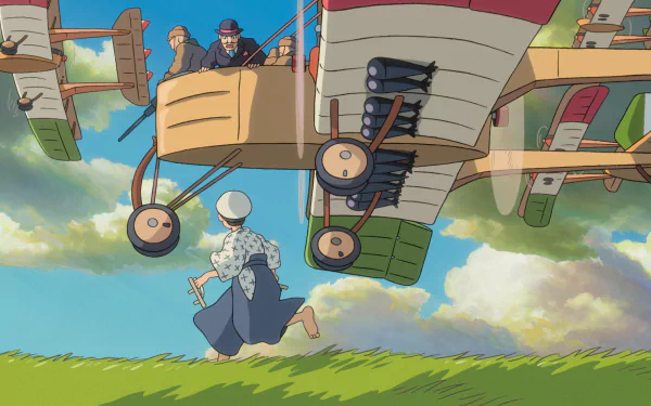 HD wallpaper of The Wind Rises featuring a character observing a flying aircraft under a cloudy sky.