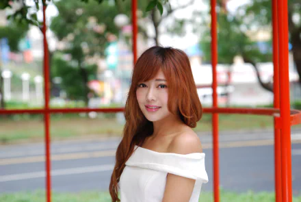 A smiling Asian Taiwanese woman, Xiao Xi, poses outdoors in a white off-shoulder top, featured in a 4K Ultra HD PC desktop wallpaper.