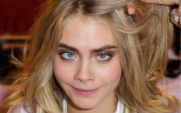 Close-up of actress Cara Delevingne showcasing her blonde hair and striking blue eyes. A vibrant 4K Ultra HD image, highlighting her expressive features.