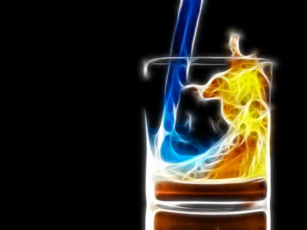 A visually striking HD desktop wallpaper depicting an artistic representation of blue and yellow elemental fluids swirling together in a glass against a black background.