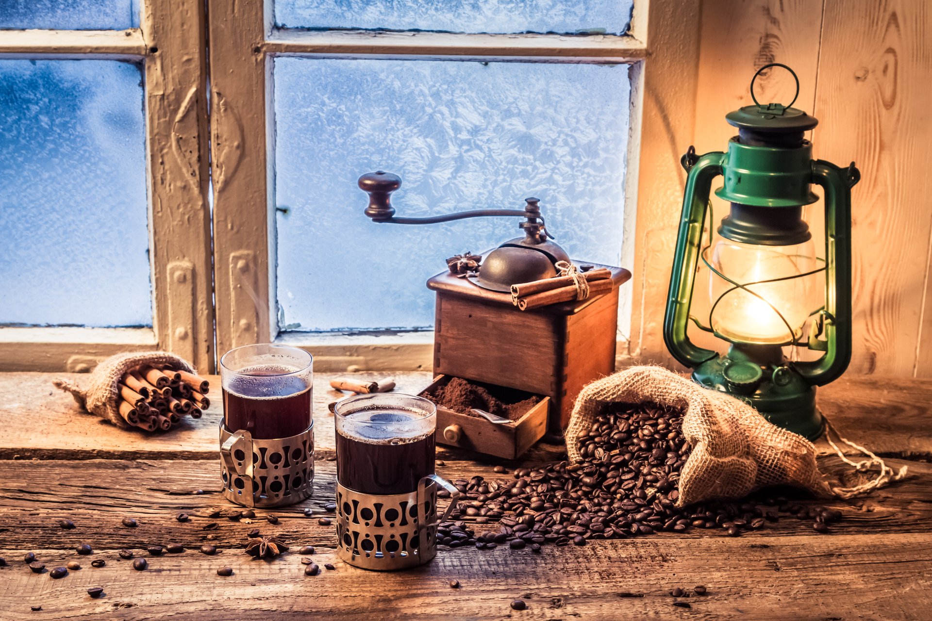 A cozy still life featuring two cups of coffee, a vintage coffee grinder, scattered coffee beans, and an antique lantern, set against a frosty window, captured in 4K Ultra HD.