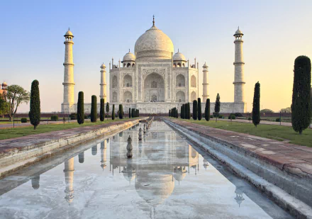 HD desktop wallpaper featuring the majestic Taj Mahal at sunrise, with its reflection beautifully mirrored in the foreground water feature.