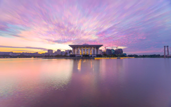 Sunrise over the Tuanku Mizan Zainal Abidin Mosque in Putrajaya, Malaysia, captured in vibrant 4K Ultra HD with serene water reflections and colorful sky.