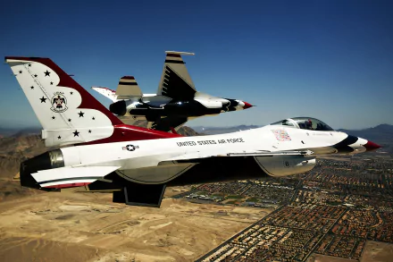 A United States Air Force Thunderbirds F-16 Fighting Falcon aircraft flies over a desert landscape in a 4K Ultra HD military wallpaper.