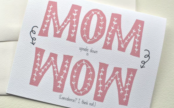 Mother's Day holiday 4K Ultra HD PC desktop wallpaper: white card with large pink block letters reading MOM (upside down WOW) with small decorative flourishes.