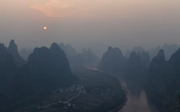 Twilight sunset over the Li River winding among karst mountains near Yangshuo, Guangxi Zhuang, China — 5K Ultra HD landscape photography desktop wallpaper.