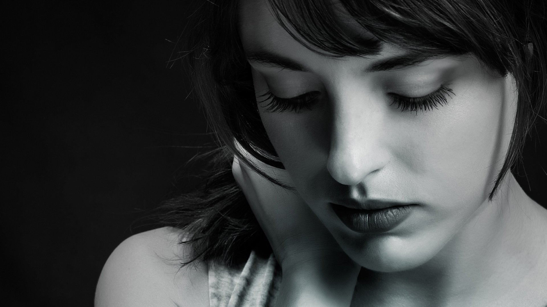 A striking black and white portrait of a woman, capturing her thoughtful expression. This HD image showcases her beauty and depth, serving as an elegant desktop wallpaper and background.