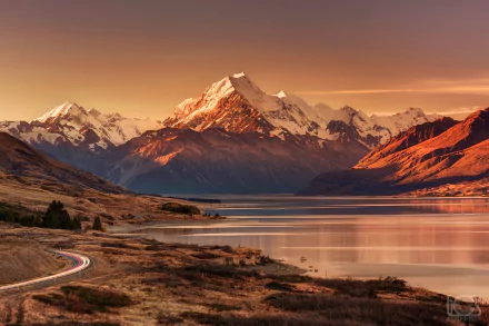 Stunning sunset over Lake Pukaki, framed by the majestic Aoraki/Mount Cook and glaciers in New Zealand's Glacier National Park, showcasing a breathtaking landscape.