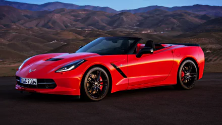 Red Chevrolet Corvette Stingray convertible on an open road with mountains at dusk — 4K Ultra HD PC desktop wallpaper showcasing the Chevrolet sports car.