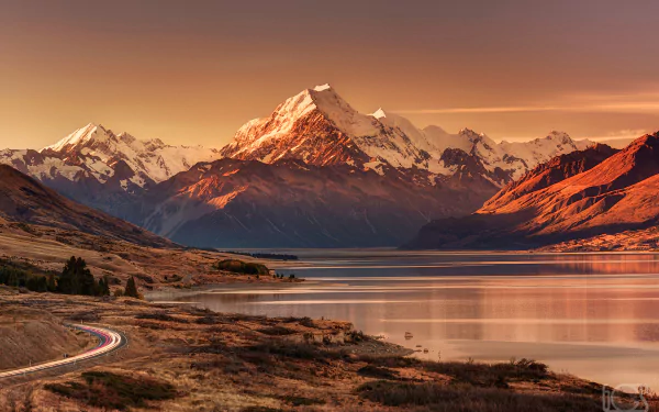 Stunning sunset over Lake Pukaki, framed by the majestic Aoraki/Mount Cook and glaciers in New Zealand's Glacier National Park, showcasing a breathtaking landscape.