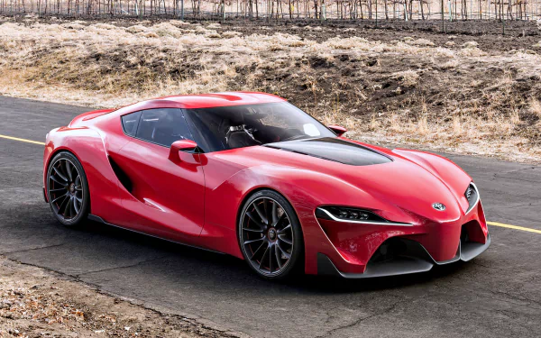 Red Toyota FT-1 concept supercar parked on a road, showcased in stunning 4K Ultra HD as a dynamic PC desktop wallpaper and background.