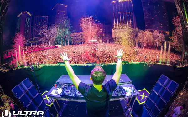 A vibrant scene from the Ultra Music Festival in Miami, featuring DJ Hardwell performing amidst a lively crowd and colorful confetti, capturing the energy of the festival.