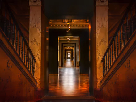 A stunning 4K Ultra HD interior view showcasing a man-made enfilade with polished floors and warm lighting, creating depth and symmetry in this architectural design.