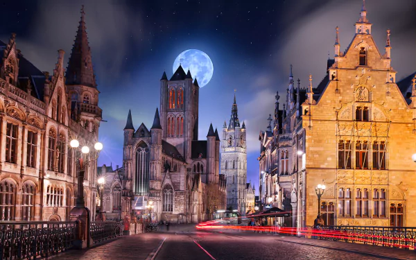A captivating night scene in Ghent, Belgium, featuring a majestic church under a full moon, framed by historic buildings along a peaceful road.