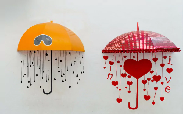 An artistic HD wallpaper featuring two unique umbrellas—an orange one with drops and a red one adorned with hearts, symbolizing love and creativity.