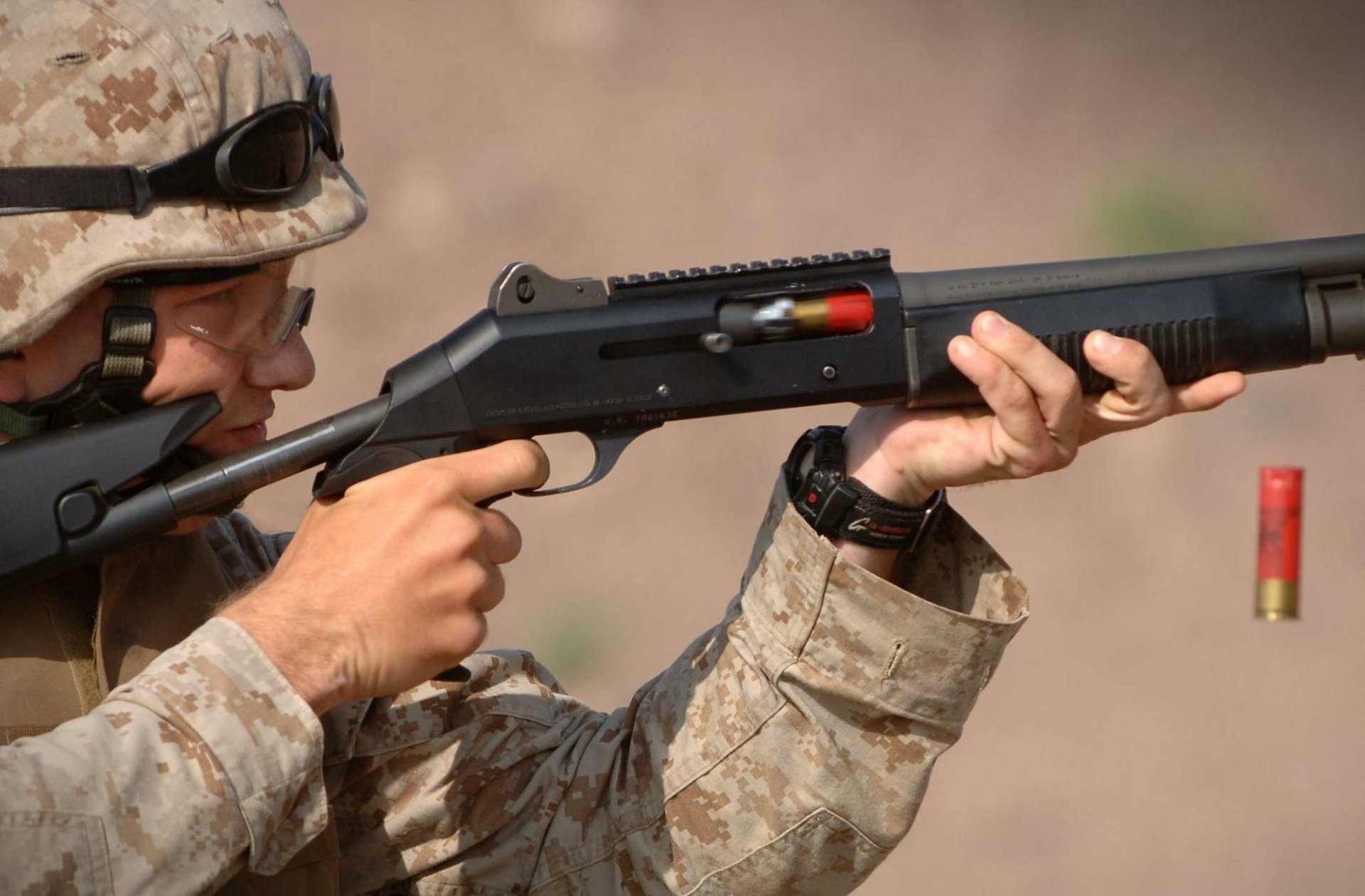HD desktop wallpaper showing a U.S. Army Infantry soldier aiming a shotgun, captured mid-shot with ejected shell visible, highlighting war and military action.