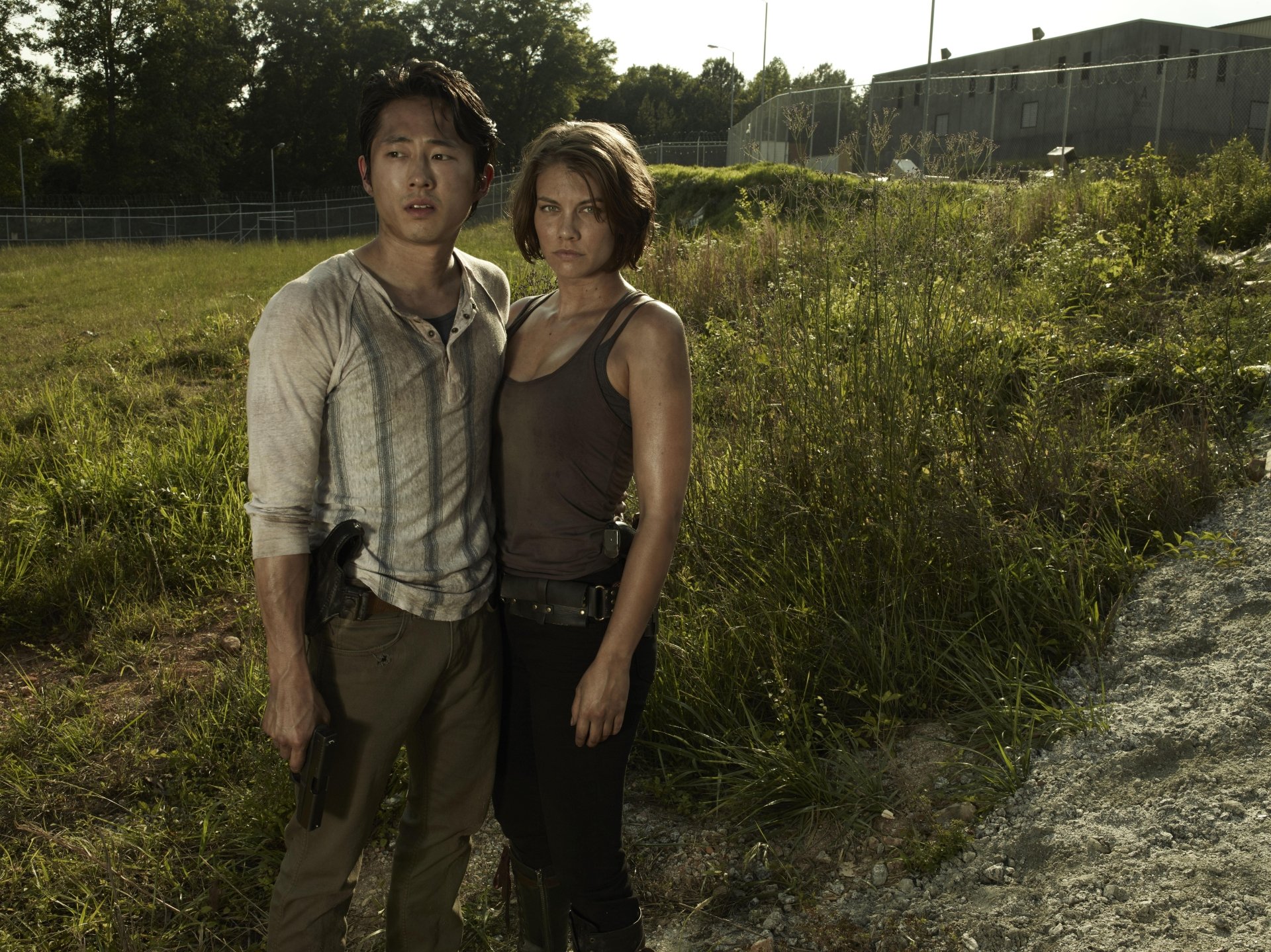 High-resolution 8K Ultra HD desktop wallpaper featuring characters from The Walking Dead TV show standing in a grassy outdoor setting.