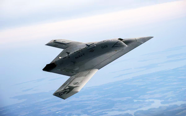A Northrop Grumman X-47B military aircraft soars through the sky, showcasing its sleek design and advanced technology in this 4K Ultra HD wallpaper.