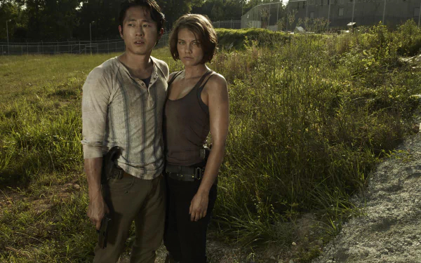 High-resolution 8K Ultra HD desktop wallpaper featuring characters from The Walking Dead TV show standing in a grassy outdoor setting.