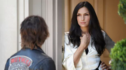 HD PC desktop wallpaper from the TV show Hemlock Grove: a woman in white stands in a doorway facing a leather-jacketed figure seen from behind, tense and atmospheric.