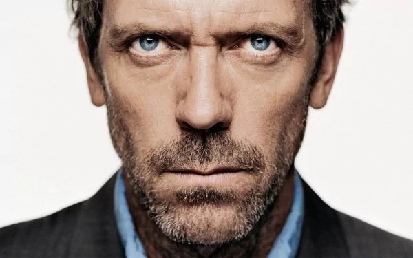 HD desktop wallpaper of Gregory House, portrayed by Hugh Laurie, from the TV show House. The image features a close-up of his intense, determined expression.